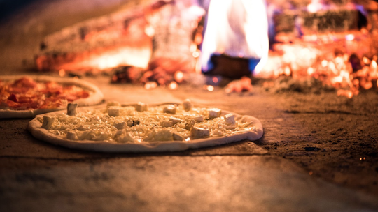 pieczenie pizz w ceglanym piecu opalanym drewnem