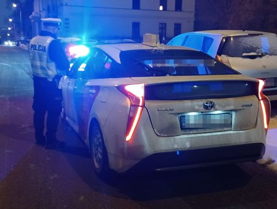 Policyjna kontrola drogowa nocą – radiowóz z włączonymi sygnałami na ulicy