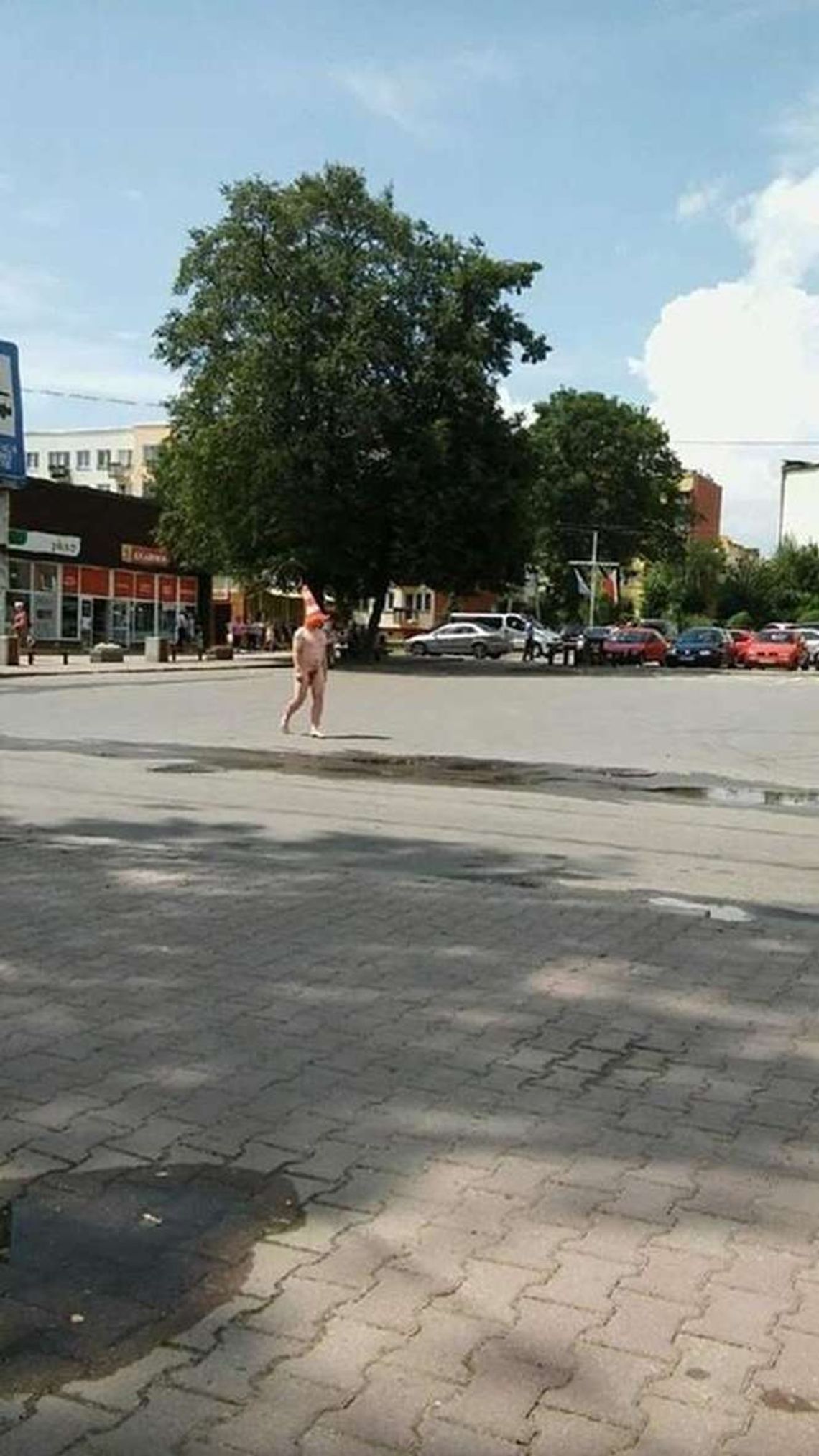 Nagi mężczyzna spacerował w centrum miasta. Z pachołkiem na głowie
