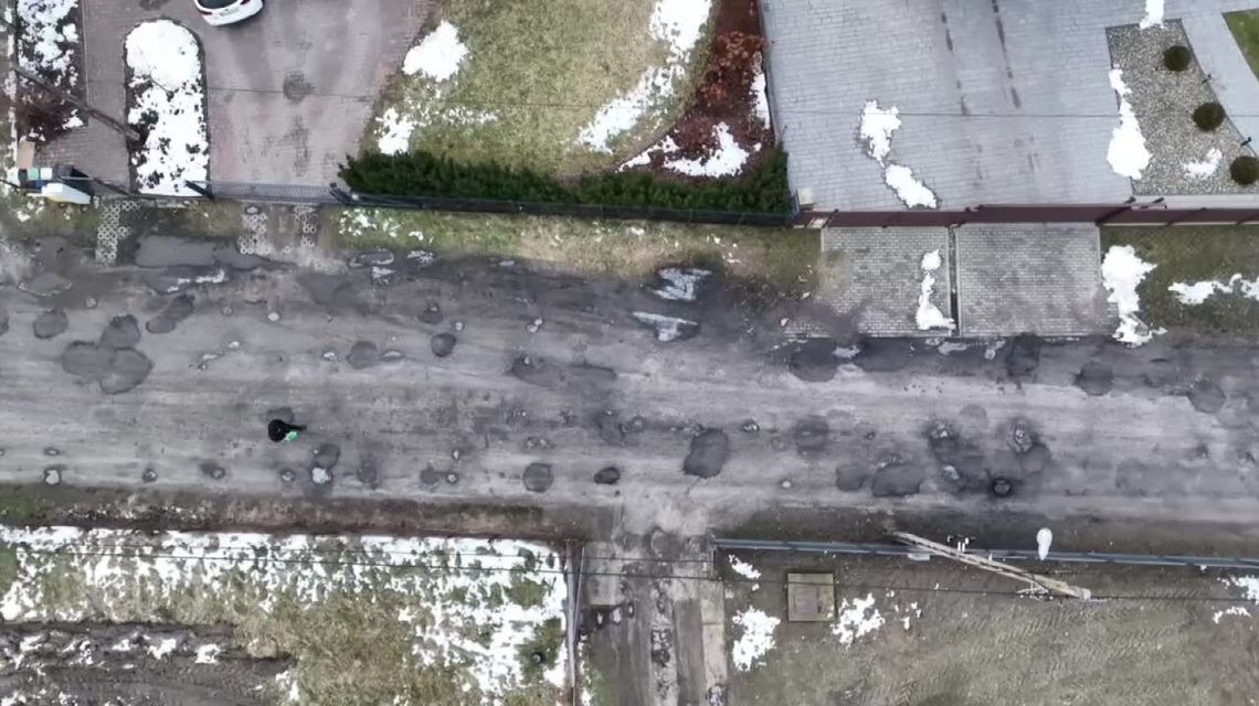 Zalali asfaltem dziurawą drogę gruntową. Wideo