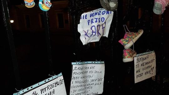 Dziecięce buty na bramie kurii w Lublinie